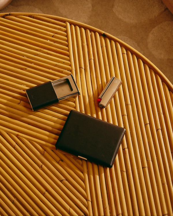 Two black rectangular objects on a textured yellow surface