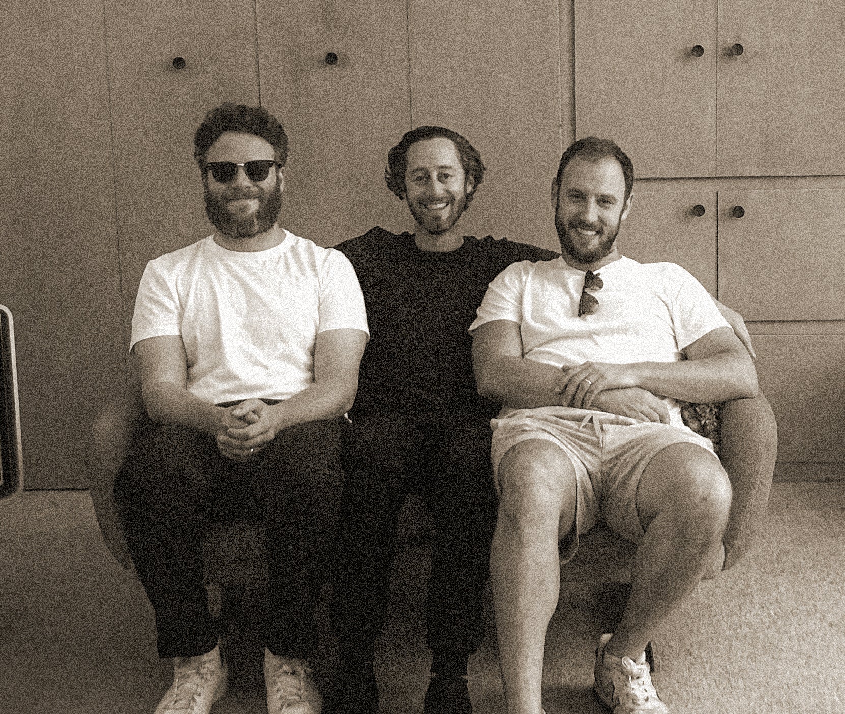 Houseplant founders Seth Rogen, Evan Goldberg and Michael Mohr sitting together on a sofa